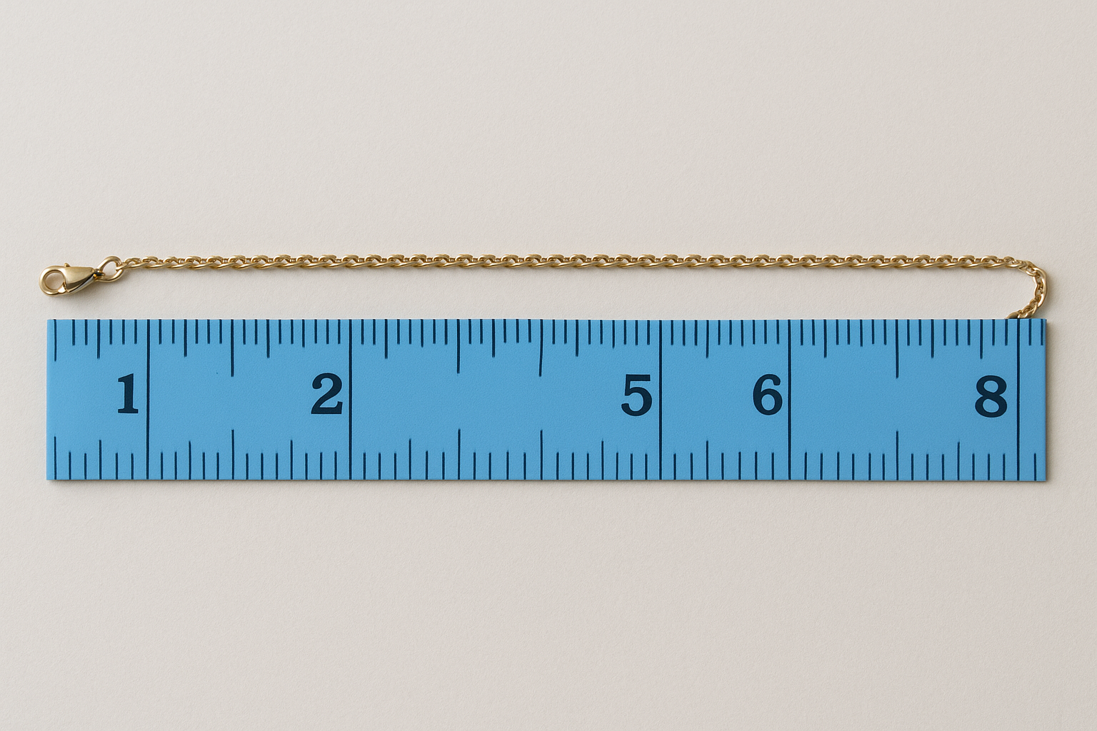Lay the chain flat and measure end to end