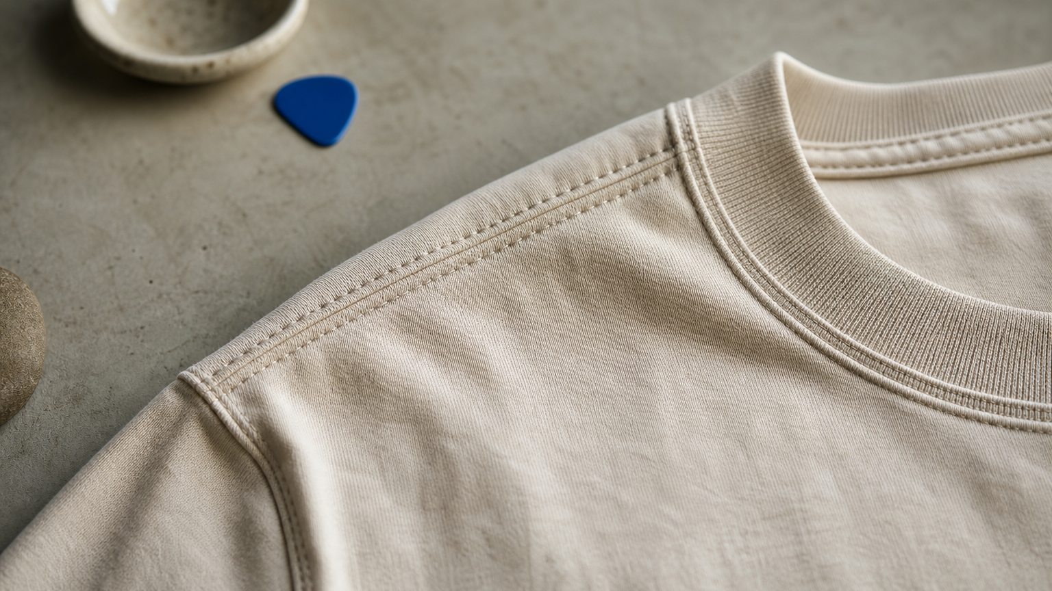 Close-up of double-needle stitching and a ribbed collar on a heavyweight t-shirt seam.