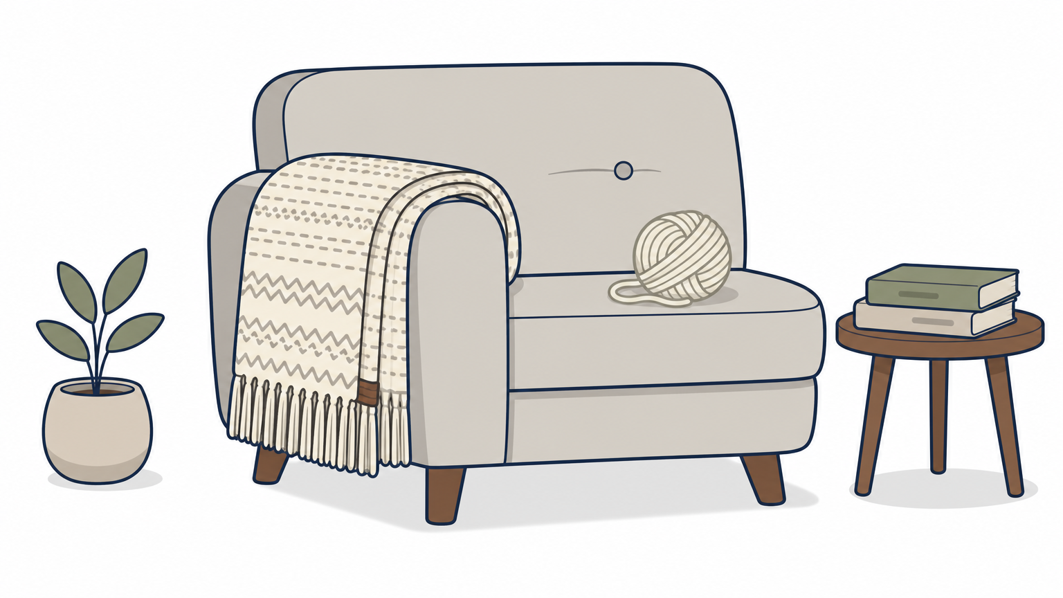 A folded handwoven wool throw draped over a sofa arm with a ball of wool resting on the cushion.